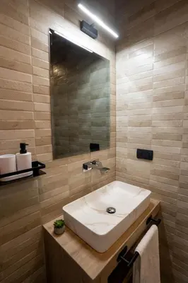 a bathroom with a white sink and a mirror at Apartman Rustic Charm in Livno