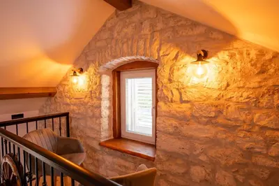 a stone staircase with a window in a stone wall at Apartman Rustic Charm in Livno