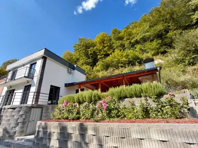a house with a garden in front of it at Divanhana na Uni in Bosanska Krupa