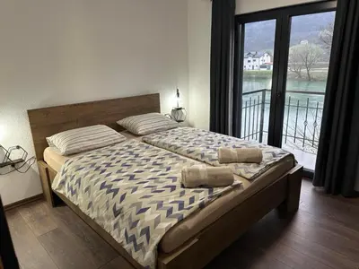 a bedroom with a bed with two pillows on it at Divanhana na Uni in Bosanska Krupa