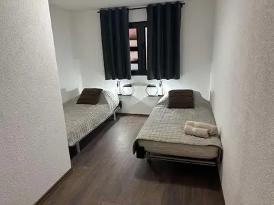 two beds in a small room with a window at Divanhana na Uni in Bosanska Krupa