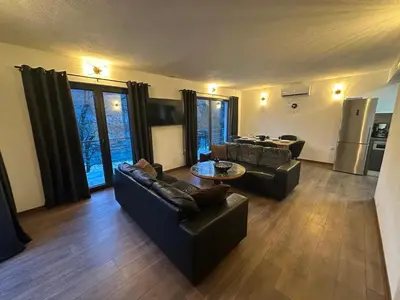 a living room with two couches and a table at Divanhana na Uni in Bosanska Krupa