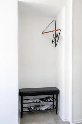 a black bench in a room with a wall at Una Riverside Heritage House in Bihać