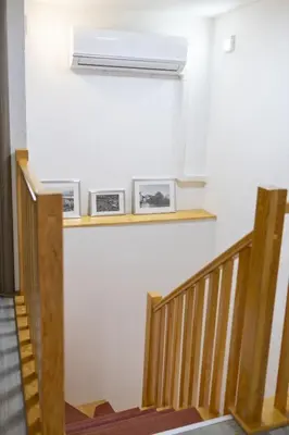 a stairway with three pictures on a wall with aperature at Una Riverside Heritage House in Bihać