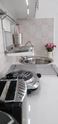 a kitchen counter with a stove and a sink at Apartment Elma in Visoko