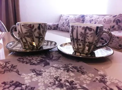 two coffee cups and saucers sitting on a table at Apartment Elma in Visoko