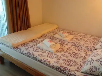 a bed with two towels on top of it at Apartment Elma in Visoko