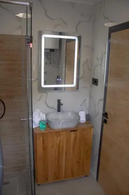 a bathroom with a sink and a mirror at Vikend kuća Ljetni San in Gračanica