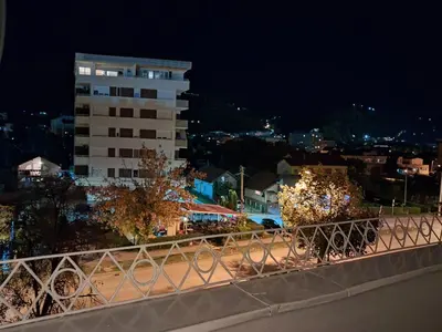 a view of a city at night with a building at Na korak do Vrbasa - blizu centra in Banja Luka
