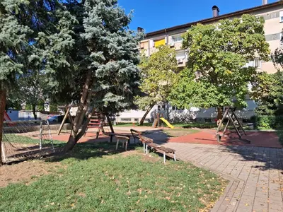 a park with two benches and a playground at Na korak do Vrbasa - blizu centra in Banja Luka