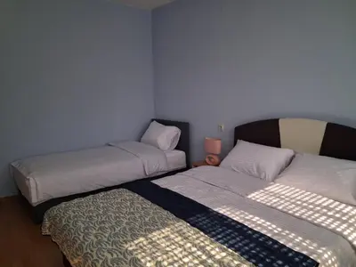 two beds in a small room with a bedskirts at Na korak do Vrbasa - blizu centra in Banja Luka