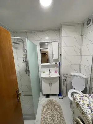 a bathroom with a sink and a shower and a toilet at Visoko Centar Apartment in Visoko