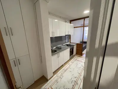 a kitchen with white cabinets and a sink at Visoko Centar Apartment in Visoko