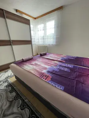 a large bed in a room with a window at Visoko Centar Apartment in Visoko