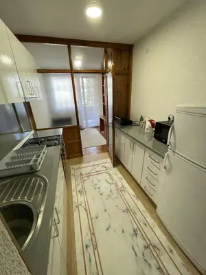 a kitchen with a stove and a refrigerator at Visoko Centar Apartment in Visoko