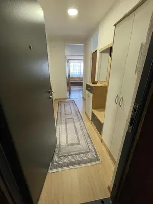 an empty hallway with a door and a rug at Visoko Centar Apartment in Visoko