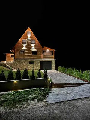 a house with lights on top of it at night at Villa Alba in Kupres