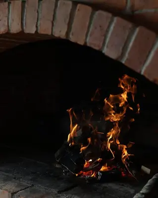a fire burning in a brick oven at Villa Alba in Kupres