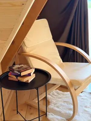 a table with books on it next to a chair at Villa Alba in Kupres