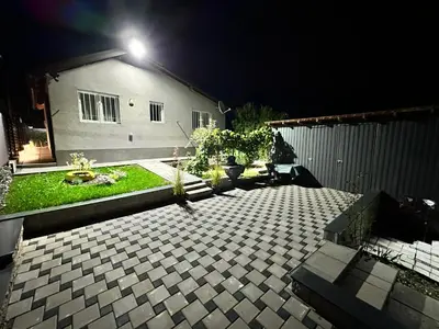 a backyard at night with a house with a light at HH Lakes Tuzla - city center, free parking! in Tuzla