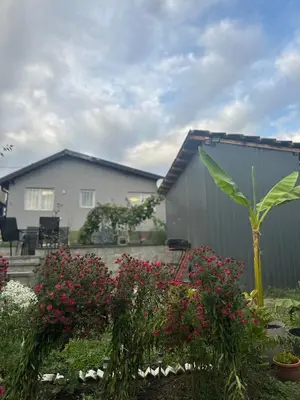 a house with a garden with flowers in the yard at HH Lakes Tuzla - city center, free parking! in Tuzla