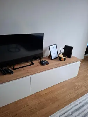 a flat screen tv sitting on top of a white cabinet at Apartman Atlas in Doboj