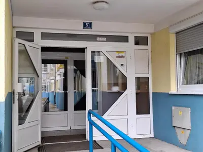 an entrance to a building with white doors at Apartman Atlas in Doboj
