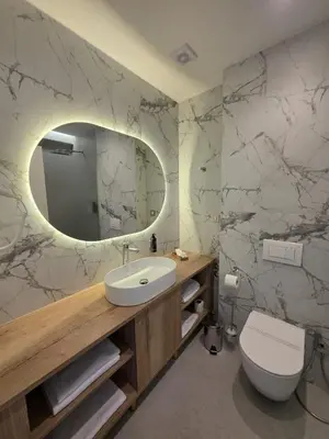 a bathroom with a sink and a toilet and a mirror at Hotel Cat Deluxe in Sanski most