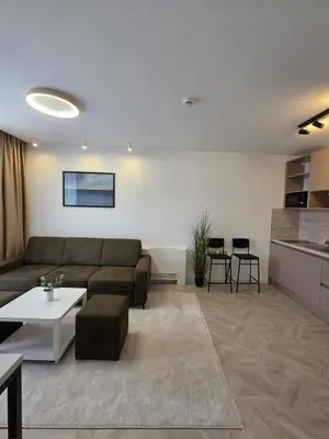 a living room with a couch and a table at Hotel Cat Deluxe in Sanski most