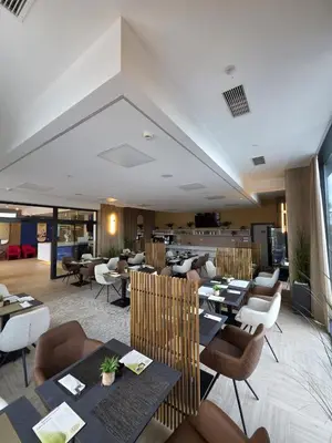 a restaurant with tables and chairs in a room at Hotel Cat Deluxe in Sanski most
