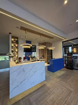 a large kitchen with a large marble counter top at Hotel Cat Deluxe in Sanski most