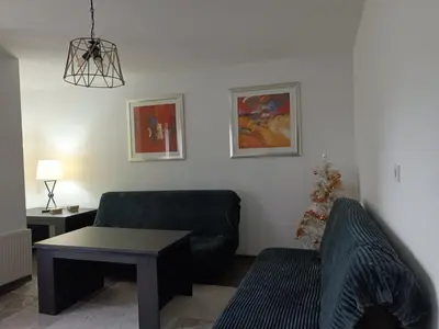 a living room with a couch and a table at Apartman 1001 in Vlasic