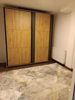 a room with two wooden doors on a wall at Apartman 1001 in Vlasic