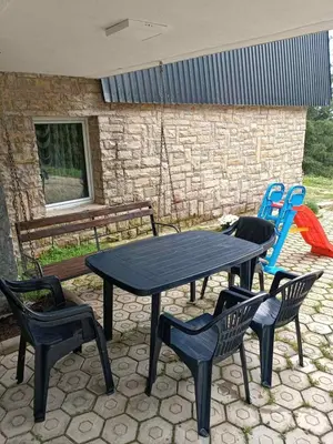 a table and two chairs and a table and chairs at Apartman 1001 in Vlasic