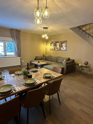 a living room with a table and a couch at Mountain house Mia Tereza in Kupres