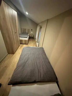 a small room with a bed and a small room with a door at Mountain house Mia Tereza in Kupres