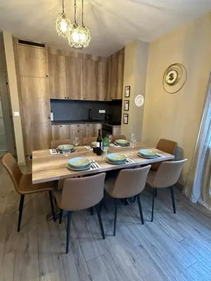 a dining room table with chairs and a large wooden table at Mountain house Mia Tereza in Kupres