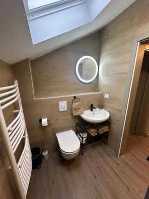 a bathroom with a toilet and a sink and two bunk beds at Mountain house Mia Tereza in Kupres