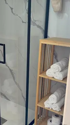 a towel rack with towels in a bathroom at Balun BLKN in Ostrožac