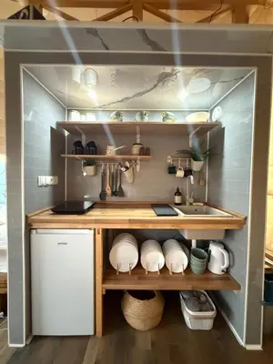 a kitchen with a counter and a sink in a room at Balun BLKN in Ostrožac