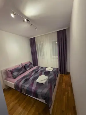 a bedroom with a bed with two towels on it at Apartman Dora'K in Doboj