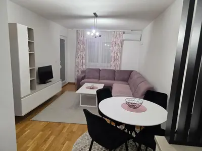 a living room with a couch and a table at Apartman Dora'K in Doboj