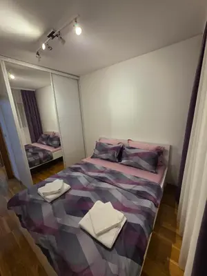 a bedroom with a bed with two towels on it at Apartman Dora'K in Doboj