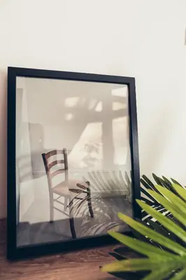 a mirror next to a chair in a room at Apartman za 5 in Banja Luka