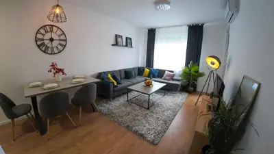 a living room with a couch and a table at Apartman za 5 in Banja Luka