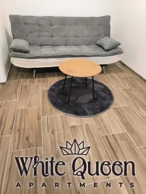 a living room with a couch and a coffee table at White Quenn Apartments in Sanski most