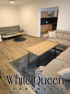 a living room with a couch and a table at White Quenn Apartments in Sanski most