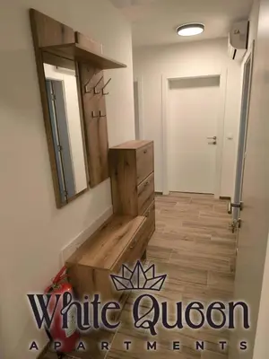 a bathroom with a vanity and a mirror on the wall at White Quenn Apartments in Sanski most