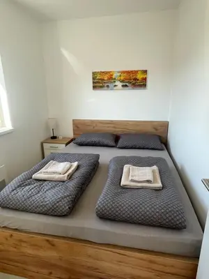 a bedroom with two beds with towels on them at Apartment Welcome in Modriča