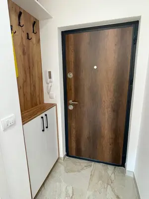 a wooden door in a room with a tile floor at Apartment Welcome in Modriča
